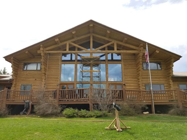 large log home with windows after blasting